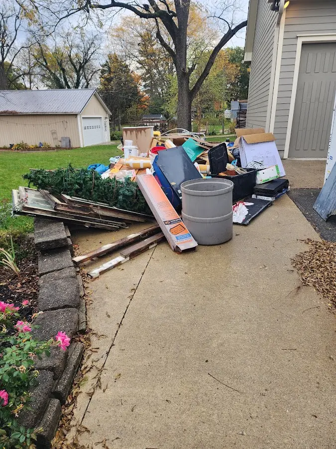 Dumpster being loaded with debris for Estate Cleanout Dumpster Rental in Dexter